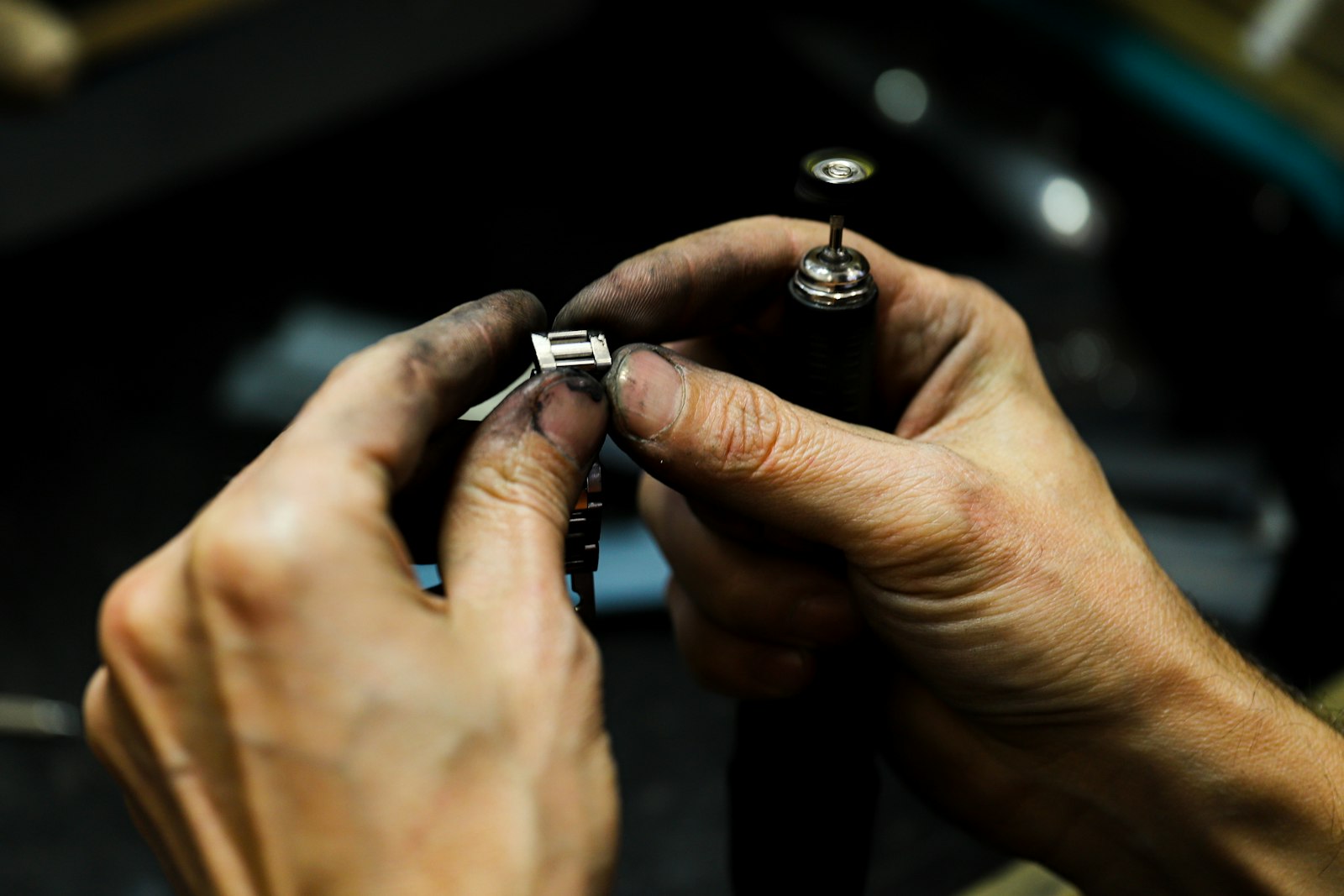 Goldsmith working a piece of metal at the bench