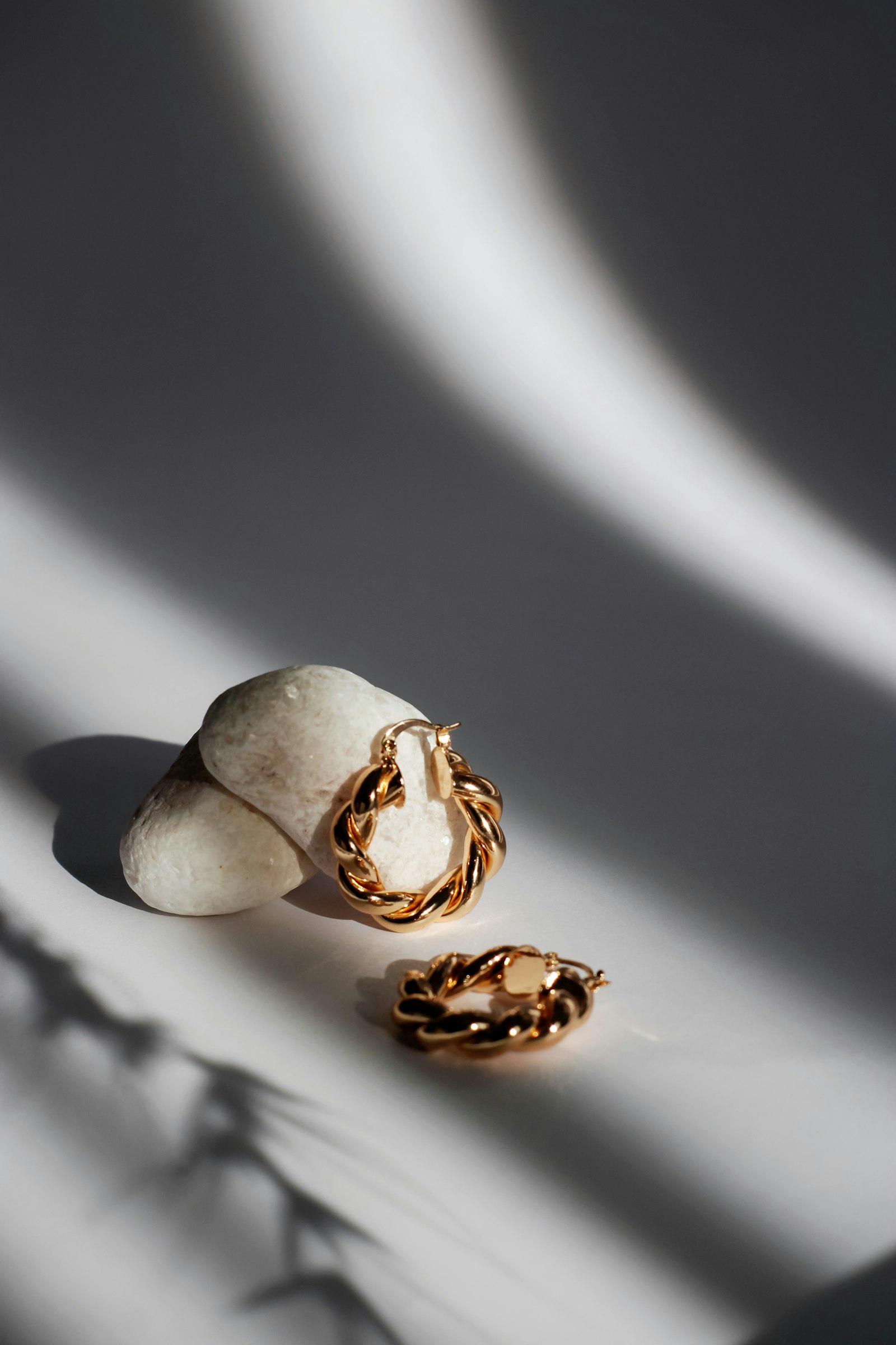 Twisted gold hoops on white stones